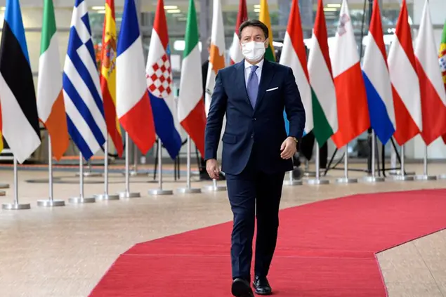 Italy's Prime Minister Giuseppe Conte arrives for an EU summit in Brussels, Friday, Oct. 16, 2020. European Union leaders meet for the second day of an EU summit, amid the worsening coronavirus pandemic, to discuss topics on foreign policy issues. (Johanna Geron, Pool via AP)