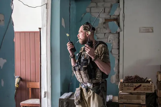 A Ukrainian soldier holds radios during heavy fighting on the front line in Severodonetsk, the Luhansk region, Ukraine, Wednesday, June 8, 2022. (AP Photo/Oleksandr Ratushniak)