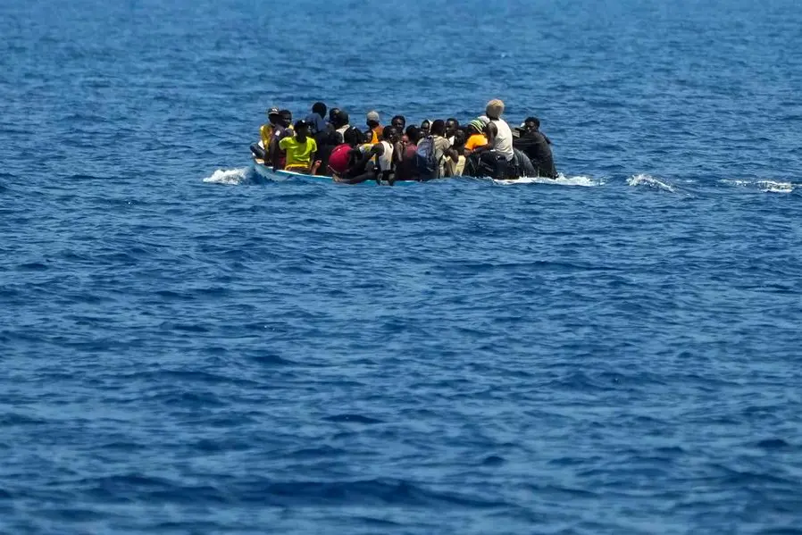 Sub-Saharan migrants sail in a crowed wooden boat before being rescued by the Italian coast guard southwest of the Italian island of Lampedusa in the Mediterranean sea, Saturday, Aug. 6, 2022. (AP Photo/Francisco Seco)