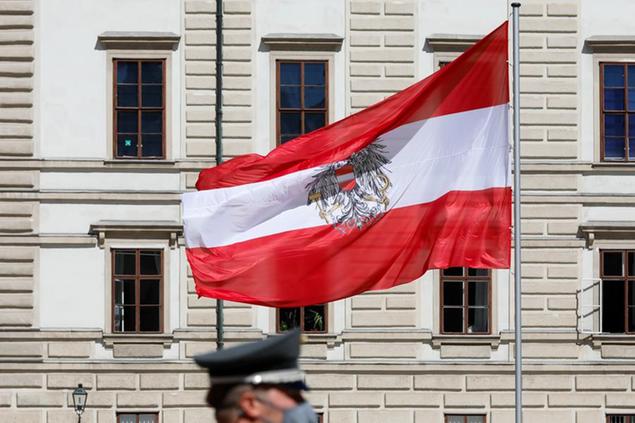 The Austrian flag is raised during an official visit from the. Estonian President Kersti Kaljulaid in Vienna, Austria, Wednesday, May 26, 2021. (AP Photo/Lisa Leutner)
