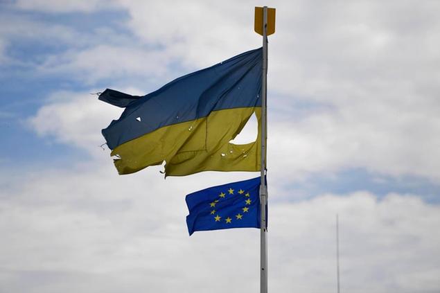 Ukrainian national flag and EU flag flutter in Malyn, Ukraine, on May 25, 2022, amid Russia's invasion of the country. (Kyodo via AP Images) ==Kyodo
