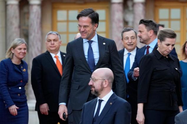 From left, Sweden's Prime Minister Magdalena Andersson, Hungary's Prime Minister Viktor Orban, Dutch Prime Minister Mark Rutte, European Council President Charles Michel, Italy's Prime Minister Mario Draghi, Luxembourg's Prime Minister Xavier Bettel and Denmark's Prime Minister Mette Frederiksen gather for a group photo at an EU summit at the Chateau de Versailles, in Versailles, west of Paris, Thursday, March 10, 2022. (AP Photo/Michel Euler)