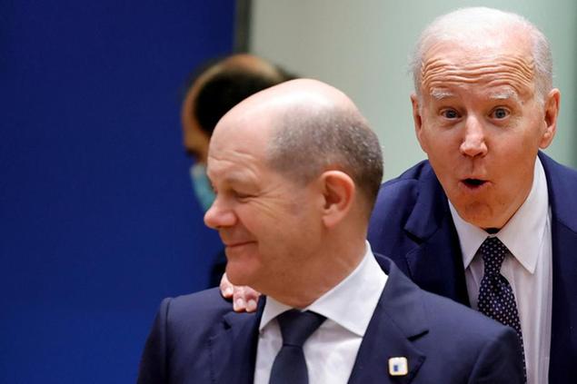 U.S. President Joe Biden, right, puts his hand on the shoulder of German Chancellor Olaf Scholz as he arrives for a round table meeting at an EU summit in Brussels, Thursday, March 24, 2022. As the war in Ukraine grinds into a second month, President Joe Biden and Western allies are gathering to chart a path to ramp up pressure on Russian President Vladimir Putin while tending to the economic and security fallout that's spreading across Europe and the world. (AP Photo/Olivier Matthys)