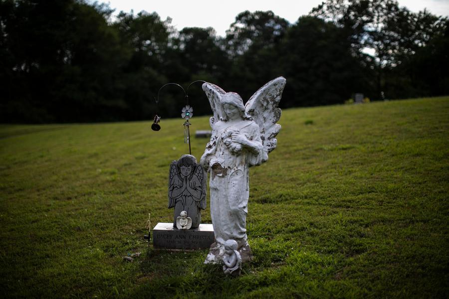 Angel statues stand beside a gravestone at the Hollister Cemetery in Glouster, Ohio, on Thursday, July 23, 2020. A 2019 study done across Appalachia found that the death rate in 2017 for opioid overdoses was 72 percent higher in Appalachian counties compared those outside the region. Ohio, meanwhile, had the country's fifth-highest rate of drug overdoses in the country in 2018. (AP Photo/Wong Maye-E)