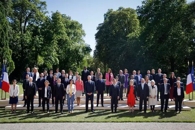 French President Emmanuel Macron, center, poses with minister in the gardens of the Elysee Palace in Paris, Monday, July 4, 2022. French President Emmanuel Macron rearranged his Cabinet on Monday in an attempt to adjust to a new political reality following legislative elections in which his centrist alliance failed to win a majority in the parliament. (Ludovic Marin, Pool via AP)