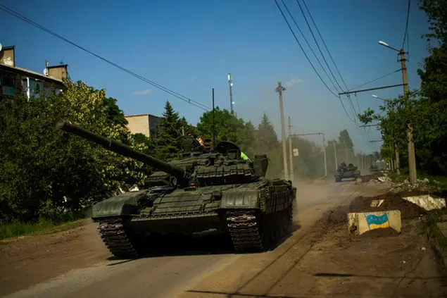 FILE - Ukrainian tanks move in Donetsk region, eastern Ukraine, Monday, May 30, 2022. Day after day, Russia is pounding the Donbas region of Ukraine with relentless artillery and air raids, making slow but steady progress to seize the industrial heartland of its neighbor. (AP Photo/Francisco Seco, file)