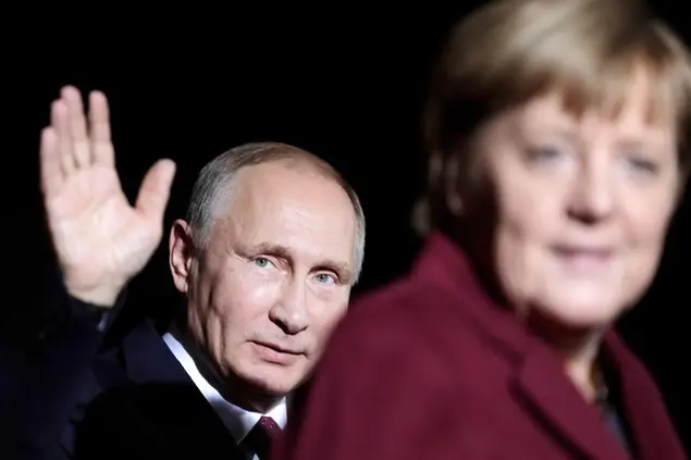FILE - President of Russia Vladimir Putin waves after he meets this time German Chancellor Angela Merkel for a summit with the leaders of Russia, Ukraine and France at the chancellery in Berlin, Oct. 19, 2016. Germany's refusal to join other NATO members in supplying Ukraine with weapons has frustrated allies and prompted some to question Berlin's resolve in standing up to Russia. (AP Photo/Markus Schreiber, File)