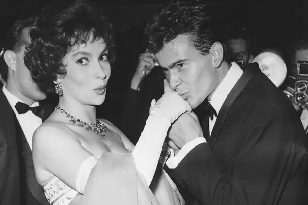 FILE - German actor Horst Buchholz kisses the hand of Italian actress Gina Lollobrigida, during the International Film Festival (Berlinale) in Berlin, Germany, July 5, 1958. (AP Photo/Werner Kreusch, File) Lollobrigida has died in Rome at age 95. Italian news agency Lapresse reported Lollobrigida’s death on Monday, Jan. 16, 2023 quoting Tuscany Gov. Eugenio Giani. (AP Photo/Werner Kreusch, File) Associated Press/LaPresse Only Italy and Spain