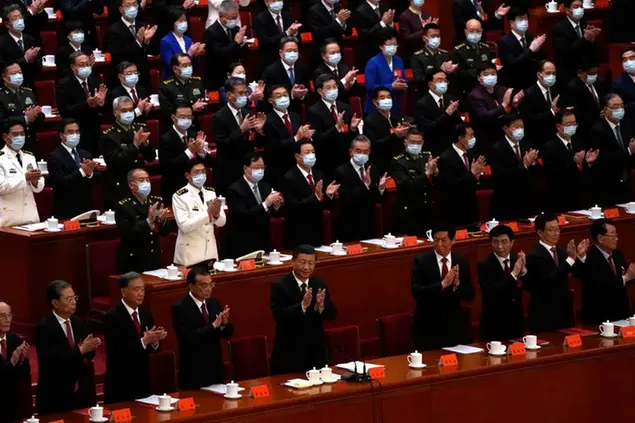 Chinese President Xi Jinping, center, and other delegates applaud during the closing ceremony of the 20th National Congress of China's ruling Communist Party at the Great Hall of the People in Beijing, Saturday, Oct. 22, 2022. (AP Photo/Andy Wong)