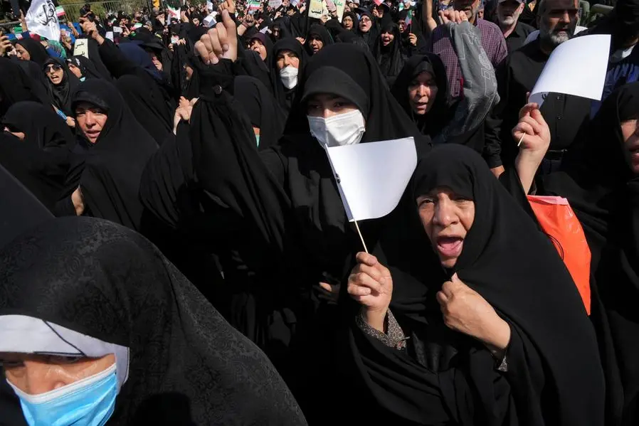 Iranian pro-government demonstrators attend a rally after their Friday prayers to condemn recent anti-government protests over the death of a young woman in police custody, in Tehran, Iran, Friday, Sept. 23, 2022. The crisis unfolding in Iran began as a public outpouring over the the death of Amini, a young woman from a northwestern Kurdish town who was arrested by the country's morality police in Tehran last week for allegedly violating its strictly-enforced dress code. (AP Photo/Vahid Salemi)