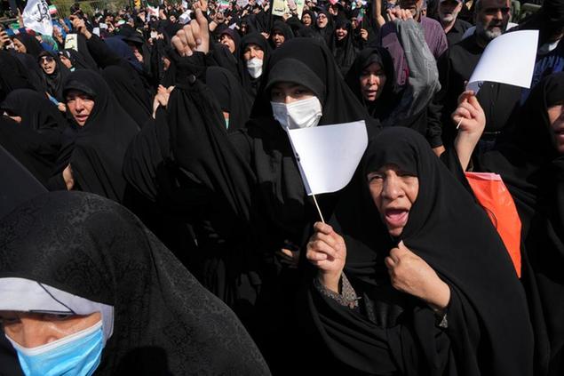 Iranian pro-government demonstrators attend a rally after their Friday prayers to condemn recent anti-government protests over the death of a young woman in police custody, in Tehran, Iran, Friday, Sept. 23, 2022. The crisis unfolding in Iran began as a public outpouring over the the death of Amini, a young woman from a northwestern Kurdish town who was arrested by the country's morality police in Tehran last week for allegedly violating its strictly-enforced dress code. (AP Photo/Vahid Salemi)