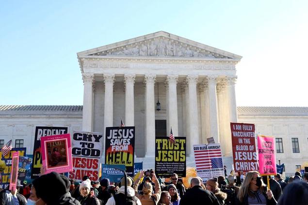 Abortion rights advocates and anti-abortion protesters demonstrate in front of the U.S. Supreme Court, Wednesday, Dec. 1, 2021, in Washington, as the court hears arguments in a case from Mississippi, where a 2018 law would ban abortions after 15 weeks of pregnancy, well before viability.(AP Photo/Parker Purifoy)