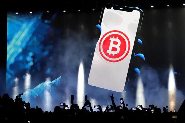 A bitcoin symbol is presented on an LED screen during the closing ceremony of a congress for cryptocurrency investors in Santa Maria Mizata, El Salvador, Saturday, Nov. 20, 2021. El Salvador's President Nayib Bukele announced during the rock concert-like atmosphere that his government will build an oceanside \\\"Bitcoin City\\\" at the base of a volcano. (AP Photo/Salvador Melendez)
