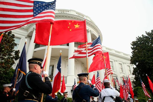 FILE - In this Sept. 25, 2015, file photo, a military honor guard await the arrival of President Barack Obama and Chinese President Xi Jinping for a state arrival ceremony on the South Lawn of the White House in Washington. (AP Photo/Andrew Harnik, File)