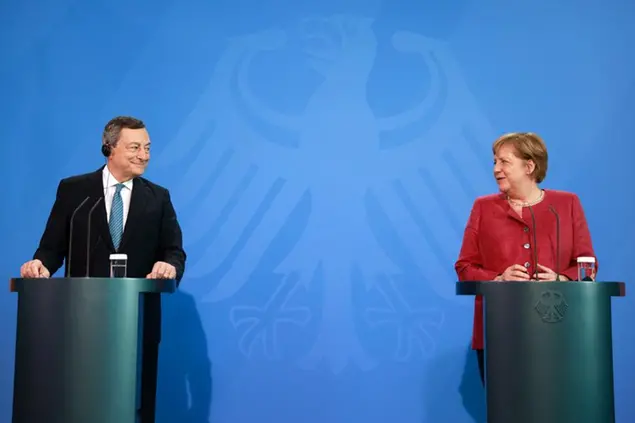 German Chancellor Angela Merkel and Italy's Prime Minister Mario Draghi give a press conference after talks ahead of the Euro summit 2021 at the Chancellery in Berlin, Monday June 21, 2021. (Odd Andersen/Pool Photo via AP)