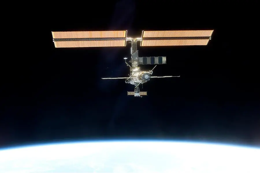 In this photo provided by NASA, the International Space Station, backdropped against black space above Earth's horizon, is seen from the Space Shuttle Discovery on March 19, 2001, after a new crew comprised of cosmonaut Yury Usachev and astronauts James Voss and Susan Helms began several months aboard the station. In the early days of the station, it was a cramped and humid, with just three rooms. It's much larger now, with six sleeping compartments, three toilets, a domed lookout and three high-tech labs. (NASA via AP)