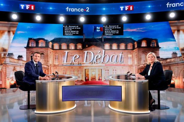 Centrist candidate and French President Emmanuel Macron, left, and far-right contender Marine Le Pen pose before a televised debate in La Plaine-Saint-Denis, outside Paris, Wednesday, April 20, 2022. In the climax of France's presidential campaign, centrist President Emmanuel Macron and far-right contender Marine Le Pen meet Wednesday evening in a one-on-one television debate that could prove decisive before Sunday's runoff vote. (Ludovic Marin, Pool via AP)
