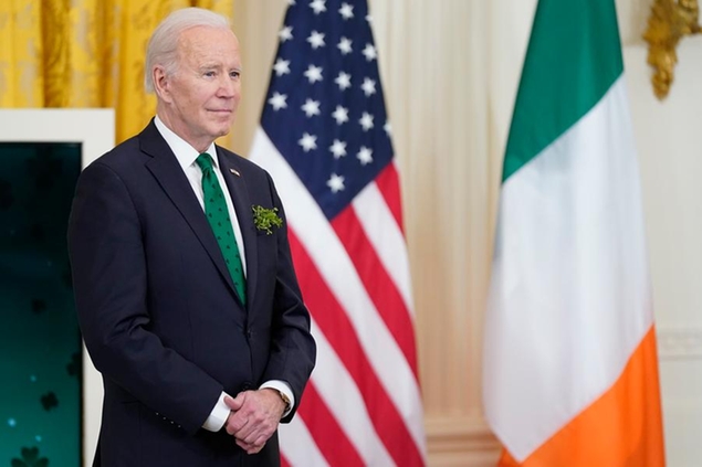 President Joe Biden waits to speak at a St. Patrick's Day celebration in the East Room of the White House, Thursday, March 17, 2022, in Washington. (AP Photo/Patrick Semansky)