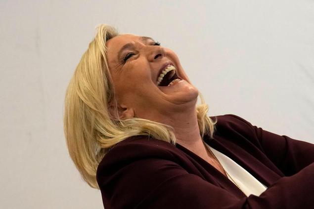 FILE - French far-right leader Marine Le Pen laughs during a press conference Tuesday, April 12, 2022 in Vernon, west of Paris. Marine Le Pen\\u00E2\\u20AC\\u2122s vision for France if the far-right leader wins Sunday\\u00E2\\u20AC\\u2122s runoff presidential election would include a ban on Muslim headscarves in public, schoolchildren in uniforms and laws passed by referendum. (AP Photo/Francois Mori)