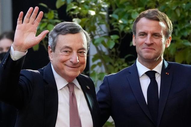 France's President Emmanuel Macron, left, poses with Italian Prime Minister Mario Draghi before a conference with several world leaders in Paris, Friday, Nov. 12, 2021. France is hosting an international conference on Libya on Friday as the North African country is heading into long-awaited elections next month. (AP Photo/Francois Mori)