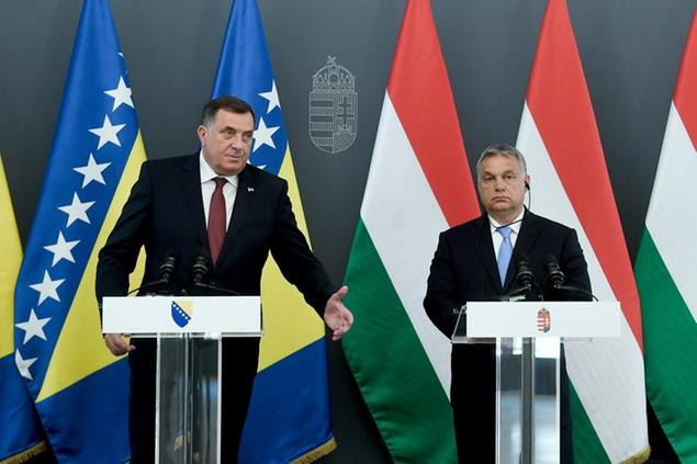 Current chairman and Serb member of the tripartite Presidency of Bosnia and Herzegovina Milorad Dodik, left, and Hungarian Prime Minister Viktor Orban, right, address the media during a joint press conference following their talks in the PM's office in Budapest, Hungary, Tuesday, June 18, 2019. (Szilard Koszticsak/MTI via AP)