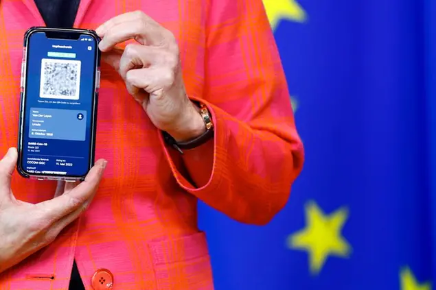 European Commission President Ursula von der Leyen shows a phone, as she gives a press statement on the new COVID-19 digital travel certificate at the European Commission headquarters in Brussels, Wednesday, June 16, 2021. (Johanna Geron/Pool Photo via AP)