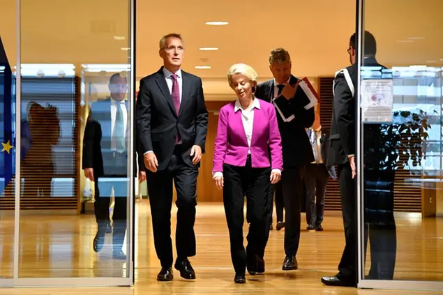 European Commission President Ursula von der Leyen, center, walks with NATO Secretary General Jens Stoltenberg, center left, prior to a meeting at EU headquarters in Brussels, Monday, Sept. 26, 2022. (AP Photo/Geert Vanden Wijngaert)