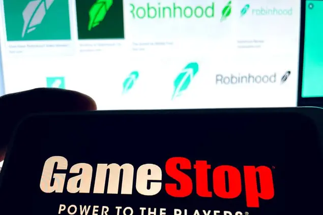 Photo by: STRF/STAR MAX/IPx 2021 1/29/21 Robinhood lifts restrictions on trading GameStop and raises $1 Billion. GameStop shares rose as much as 100% in pre-market trading. STAR MAX Photo: Robinhood and GameStop logos photographed off Apple devices.