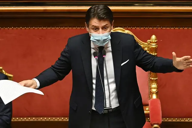 Premier Giuseppe Conte delivers his speech at the Senate, in Rome, Tuesday, Jan. 19, 2021. Conte fights for his political life with an address aimed at shoring up support for his government, which has come under fire from former Premier Matteo Renzi's tiny but key Italia Viva (Italy Alive) party over plans to relaunch the pandemic-ravaged economy. (Andreas Solaro/Pool via AP)