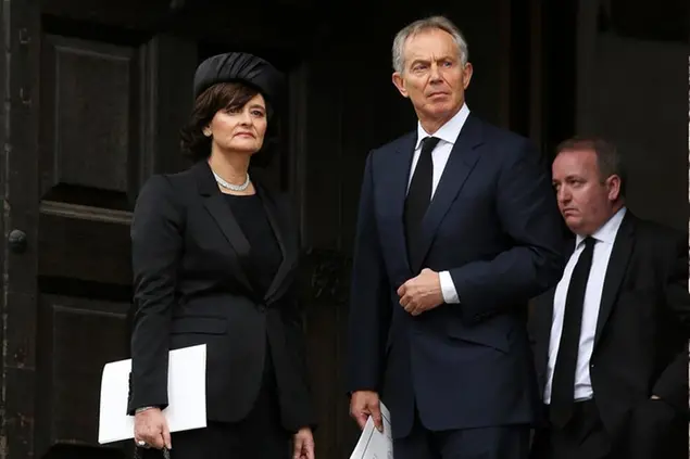 FILE - In this April 17, 2013 file photo former British Prime Minister Tony Blair and his wife Cherie Blair leave the ceremonial funeral of former British Prime Minister Baroness Thatcher in St Paul's Cathedral in London. Hundreds of world leaders, powerful politicians, billionaires, celebrities, religious leaders and drug dealers have been stashing away their investments in mansions, exclusive beachfront property, yachts and other assets for the past quarter century, according to a review of nearly 12 million files obtained from 14 different firms located around the world. The report released Sunday, Oct. 3, 2021, by the International Consortium of Investigative Journalists involved 600 journalists from 150 media outlets in 117 countries. Former British Prime Minister Tony Blair is one of 330 current and former politicians identified as beneficiaries of the secret accounts. (AP Photo/Chris Jackson, Pool, File)