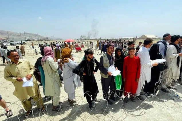 Hundreds of people gather outside the international airport in Kabul, Afghanistan, Tuesday, Aug. 17, 2021. The Taliban declared an “amnesty” across Afghanistan and urged women to join their government Tuesday, seeking to convince a wary population that they have changed a day after deadly chaos gripped the main airport as desperate crowds tried to flee the country. (AP Photo)