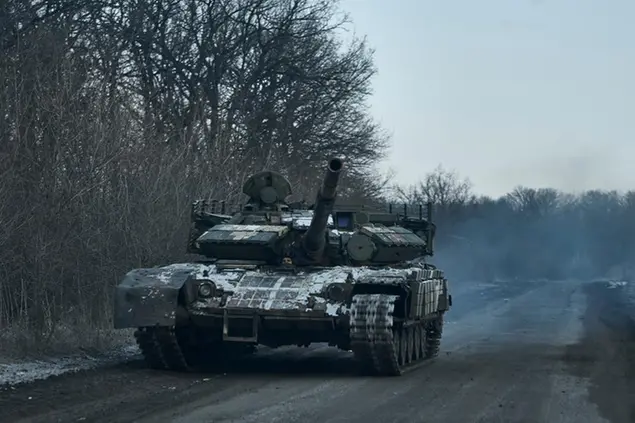 A Ukrainian tank rides to its position in the frontline in Bakhmut, Donetsk region, Ukraine, Friday, Feb. 10, 2023. (AP Photo/Libkos)