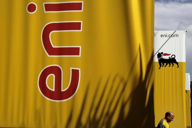 FILE - In this Friday, Feb. 23, 2018 file photo, an employee walks by banners with name and sign of energy firm Eni at Strovolos area in capital Nicosia, Cyprus. Oil giants Shell and Italy\\u2019s Eni were acquitted Wednesday, March 17, 2021 of corruption charges in a $1.1 billion bribery case involving control of a lucrative oil block on Nigeria. In addition the companies, Eni\\u2019s current CEO, his predecessor and a former Nigerian oil minister were among 13 defendants acquitted in the three-year-old trial, involving the 2011 purchase of the OPL245 block. (AP Photo/Petros Karadjias, File)