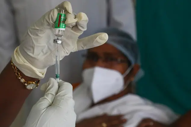 A health worker, left, prepares to administer COVID-19 vaccine to a hospital staff at a government Hospital in Hyderabad, India, Monday, Jan. 18, 2021. India started inoculating health workers Saturday in what is likely the world's largest COVID-19 vaccination campaign, joining the ranks of wealthier nations where the effort is already well underway. (AP Photo/Mahesh Kumar A.)