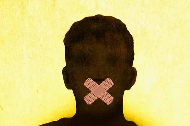 Anonymous man with mouth taped shut (Ikon Images via AP Images)