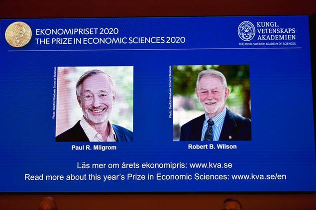 Winners of the Sveriges Riksbank Prize in Economic Sciences in Memory of Alfred Nobel for 2020 at a press conference in Stockholm, Monday Oct. 12, 2020. Americans Paul R. Milgrom, left, and Robert B. Wilson have won the Nobel Prize in economics for \\\\\\\"improvements to auction theory and inventions of new auction formats.\\\\\\\" (Anders Wiklund/TT via AP)