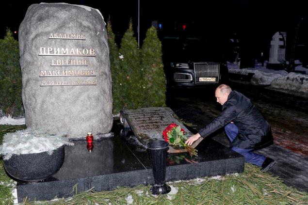 Russian President Vladimir Putin lays a bunch of flowers at the grave of former Russian Prime Minister Yevgeny Primakov at the Novodevichy Cemetery in Moscow, Russia, Monday, Feb. 1, 2021. Primakov, a former prime minister who also served as Russia's top diplomat and foreign intelligence chief during a long and distinguished career. (Mikhail Klimentyev, Sputnik, Kremlin Pool Photo via AP)