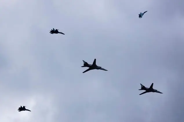 Two Tu-22M3 bombers escorted by Su-35 fighters of the Russian air force fly during the Union Courage-2022 Russia-Belarus military drills at the Obuz-Lesnovsky training ground in Belarus, Saturday, Feb. 19, 2022. Russia has deployed troops to its ally Belarus for sweeping joint military drills that run through Sunday, fueling Western concerns that Moscow could use the exercise to attack Ukraine from the north. (AP Photo/Alexander Zemlianichenko Jr)