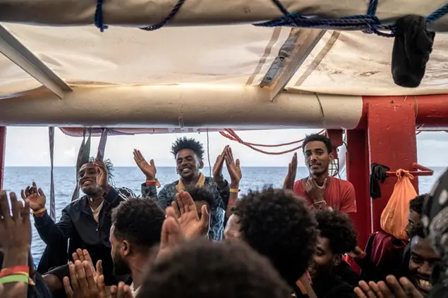 Migrants react on board the humanitarian ship Ocean Viking heading to France with 230 migrants saved from the Mediterranean Sea, Thursday, Nov. 10, 2022. France will let the migrants disembark in Toloun. (AP Photo/Vincenzo Circosta)