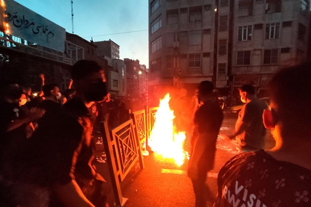 In this Wednesday, Sept. 21, 2022, photo taken by an individual not employed by the Associated Press and obtained by the AP outside Iran, protesters make fire and block the street during a protest over the death of a woman who was detained by the morality police, in downtown Tehran, Iran. Iranians saw their access to Instagram, one of the few Western social media platforms still available in the country, disrupted on Wednesday following days of the mass protests. (AP Photo)