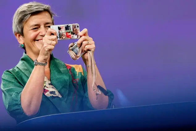 European Commissioner for Europe fit for the Digital Age Margrethe Vestager takes a photo with her mobile phone during a media conference on the Digital Decade package: high performance computing and connectivity, at EU headquarters in Brussels, Friday, Sept. 18, 2020. (AP Photo/Olivier Matthys, Pool)