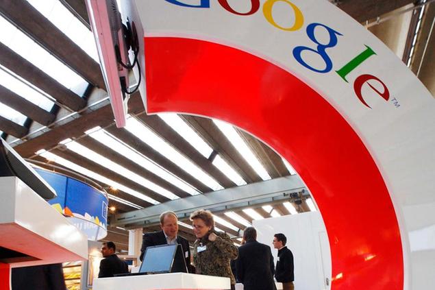 **FILE** In this Oct. 11, 2007 file photo, visitors look at an information screen at the Google Book Search stand at the International Frankfurt Book Fair 'Frankfurter Buchmesse' in Frankfurt, Germany. A settlement has been reached Tuesday, Oct. 28, 2008, in the lawsuit against Google over the Internet search engine's use of copyrighted material. (AP Photo/Jens Meyer, file)