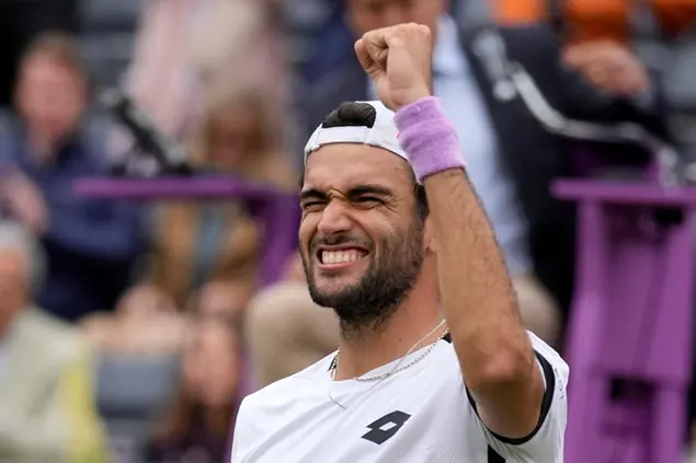 Matteo Berrettini of Italy celebrates winning at match point against Alex de Minaur of Australia during their semifinal singles tennis match at the Queen's Club tournament in London, Saturday, June 19, 2021. (AP Photo/Kirsty Wigglesworth)