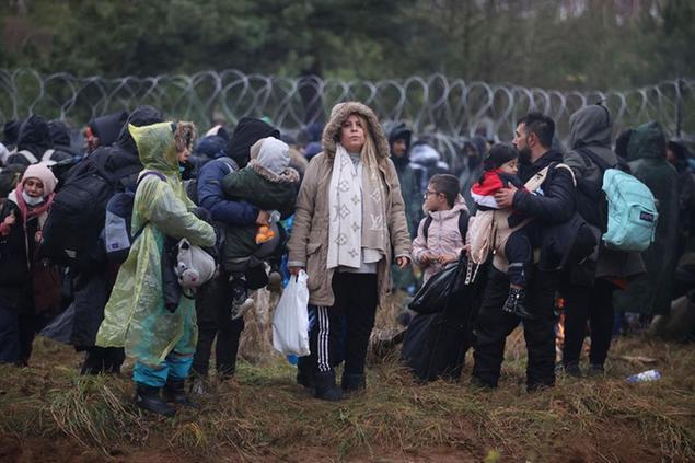 FILE - Migrants from the Middle East and elsewhere gather at the Belarus-Poland border near Grodno, Belarus, Monday, Nov. 8, 2021. For most of his 27 years as the authoritarian president of Belarus, Alexander Lukashenko has disdained democratic norms, making his country a pariah in the West and bringing him the sobriquet of \\u00E2\\u20AC\\u0153Europe\\u00E2\\u20AC\\u2122s last dictator.\\\" Now, his belligerence is directly affecting Europe. (Leonid Shcheglov/BelTA via AP, File)