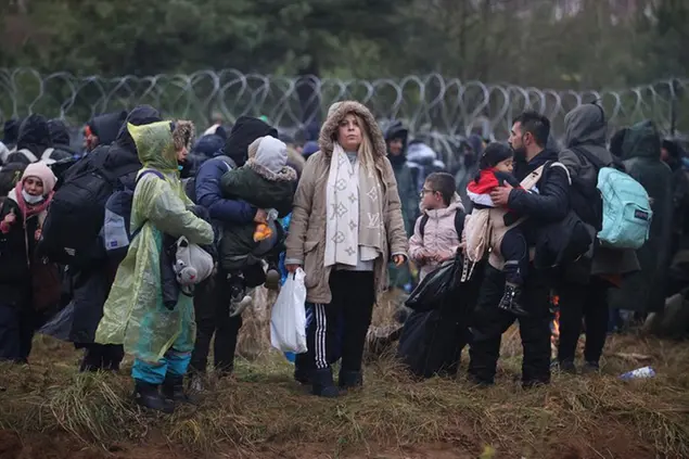 FILE - Migrants from the Middle East and elsewhere gather at the Belarus-Poland border near Grodno, Belarus, Monday, Nov. 8, 2021. For most of his 27 years as the authoritarian president of Belarus, Alexander Lukashenko has disdained democratic norms, making his country a pariah in the West and bringing him the sobriquet of â€œEuropeâ€™s last dictator.\\\" Now, his belligerence is directly affecting Europe. (Leonid Shcheglov/BelTA via AP, File)