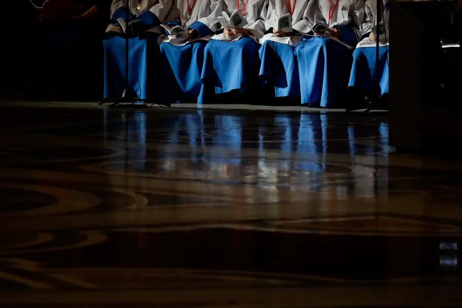 FILE - In this Nov. 13, 2016 file photo shows altar boys holding their booklets of prayers as they wait for the start of a Mass celebrated by Pope Francis on the occasion of the homeless jubilee, inside St. Peter's Basilica, at the Vatican. Pope Benedict XVI has addressed sex abuse scandals, but Vatican City still has no policy in place to protect children from pedophile priests or require suspected abuse to be reported to police. (AP Photo/Gregorio Borgia, files)