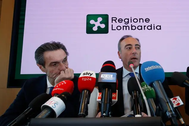 Giulio Gallera, Health Counselor for the Lombardy Region, right, is flanked by Attilio Fontana, president of Lombardy region, during a press conference in Milan, Italy, Friday, 21, 2020. In Italy, three more people, from two Lombardy towns, tested positive for the virus, the first cases of contagion among Italians who hadn’t been to China, authorities said. (AP Photo/Antonio Calanni)