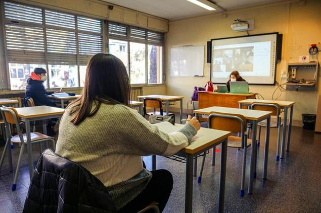 Students attend their lessons at the Aristofane high school in Rome, Monday, Jan. 18, 2021. High schools in Italy are gradually reopening after almost one year of e-learning since they were closed back in March 2020 due to the first wave of Covid-19. Only 50% of students and disabled students will be allowed to follow lessons in person at the time, the remaining 50% will follow the lesson via the internet. (AP Photo/Paolo Santalucia)