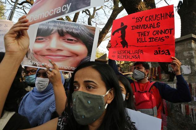 People hold placards demanding the release of Indian climate activist Disha Ravi, during a protest in Bengaluru, India, Monday, Feb.15 2021. The 22 years old activist was arrested Saturday for circulating a document on social media that allegedly incited protesting farmers to turn violent last month. (AP Photo/Aijaz Rahi)