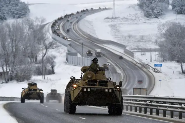 FILE - A convoy of Russian armored vehicles moves along a highway in Crimea, Jan. 18, 2022. Amid a buildup of Russian troops near Ukraine, Moscow has denied planning an attack on Ukraine but urged the U.S. and its allies to provide a binding pledge that NATO won't expand to Ukraine and won't deploy military assets there _ a demand rejected by the West. (AP Photo, File)